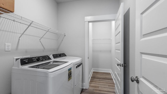 9869 Starling Dr, Pensacola, FL 32506 - laundry area featuring independent washer and dryer and dark wood-style floors