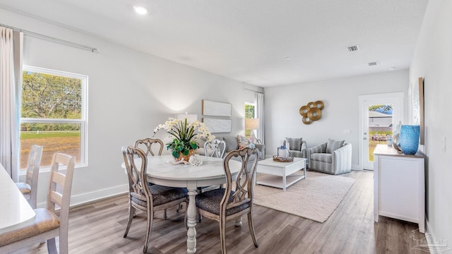 9869 Starling Dr, Pensacola, FL 32506 - dining room with healthy amount of natural light, wood finished floors, and baseboards