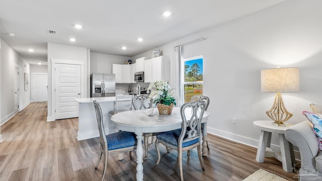 9869 Starling Dr, Pensacola, FL 32506 - dining room featuring baseboards, light wood-style flooring, and recessed lighting
