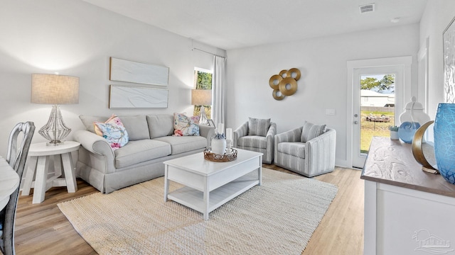 9869 Starling Dr, Pensacola, FL 32506 - living area featuring light wood-style floors and healthy amount of natural light