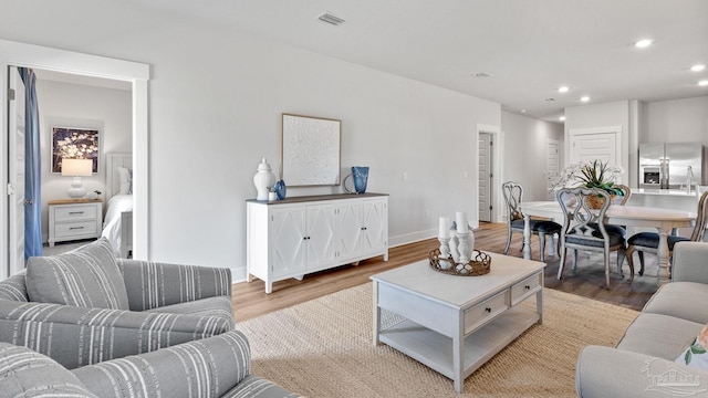 9869 Starling Dr, Pensacola, FL 32506 - living area with wood finished floors, recessed lighting, and baseboards