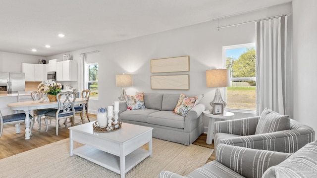 9869 Starling Dr, Pensacola, FL 32506 - living room featuring healthy amount of natural light, light wood-style flooring, and recessed lighting
