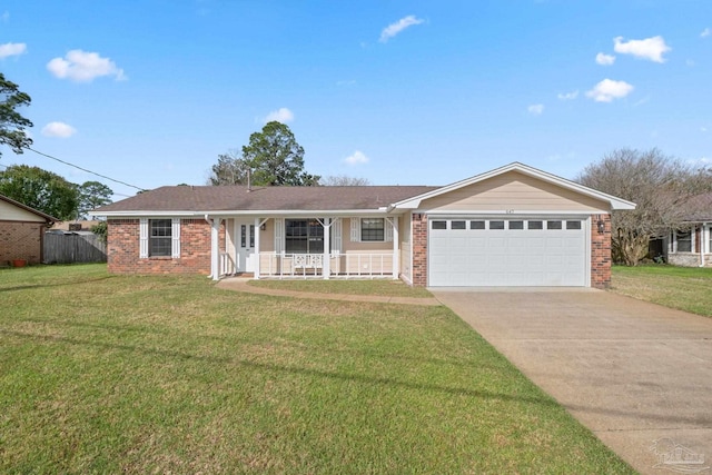 ranch-style house featuring a front yard, brick siding, an attached garage, and driveway