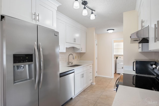 kitchen featuring a sink, light countertops, white cabinets, under cabinet range hood, and appliances with stainless steel finishes