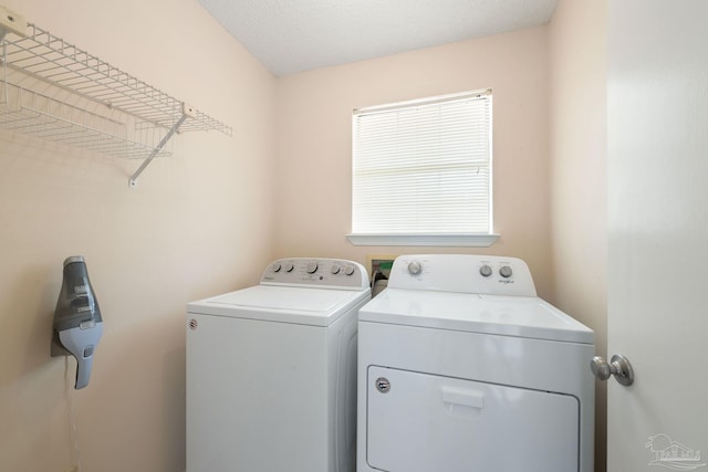 laundry room with laundry area and washing machine and clothes dryer