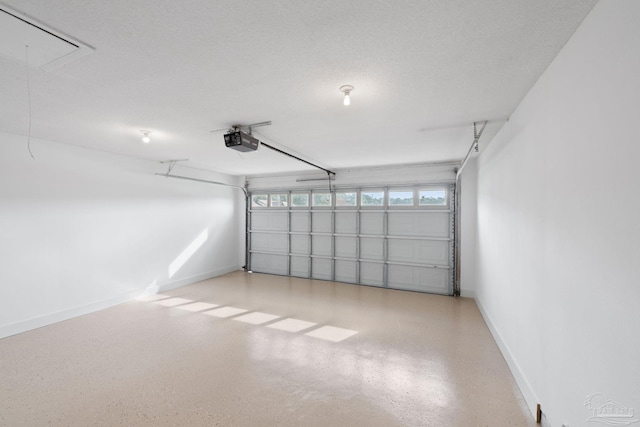 garage featuring a garage door opener and baseboards