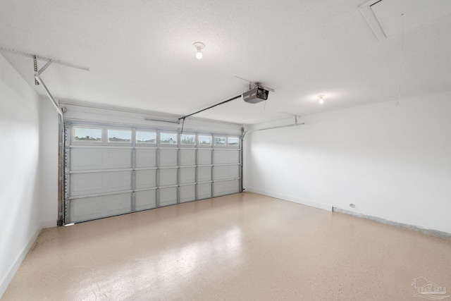 garage with a garage door opener and baseboards