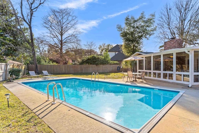 view of swimming pool featuring a fenced backyard, a lawn, a fenced in pool, and a patio