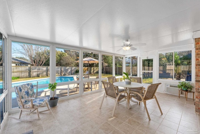 sunroom with an AC wall unit and plenty of natural light