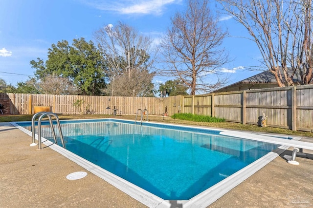 view of pool with a fenced in pool, a fenced backyard, a patio, and a diving board