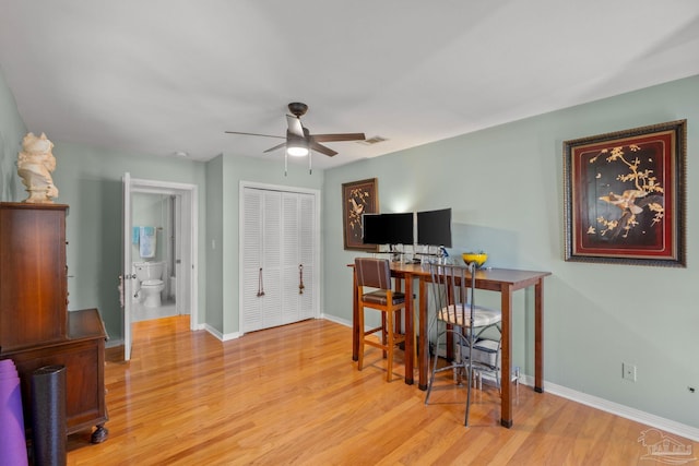 office area featuring ceiling fan, wood finished floors, visible vents, and baseboards