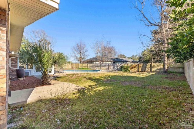 view of yard with a patio area, a fenced backyard, and a fenced in pool