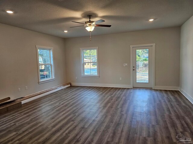 unfurnished room with dark wood-type flooring, ceiling fan, and a textured ceiling