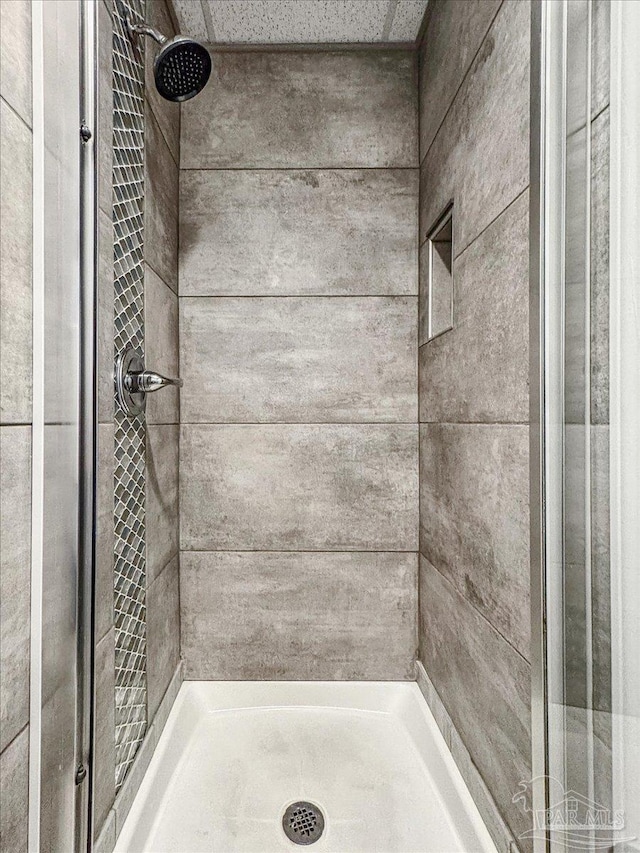 bathroom with a tile shower