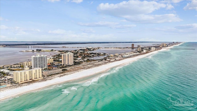 aerial view with a water view and a beach view