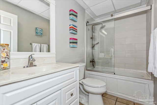 full bathroom featuring enclosed tub / shower combo, vanity, toilet, and tile patterned flooring