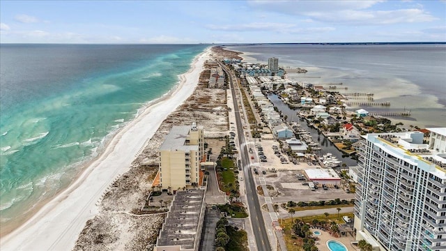 birds eye view of property featuring a water view and a beach view