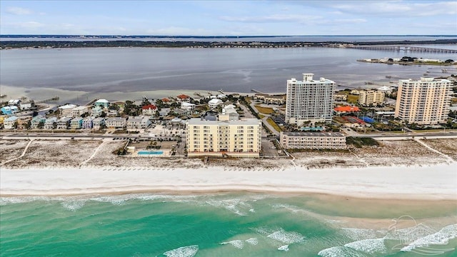 birds eye view of property with a beach view and a water view