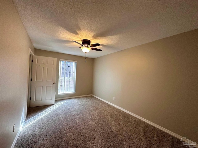 unfurnished bedroom featuring ceiling fan, carpet floors, and a textured ceiling