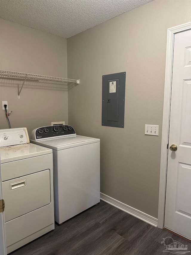 laundry area featuring separate washer and dryer, a textured ceiling, electric panel, and dark hardwood / wood-style flooring