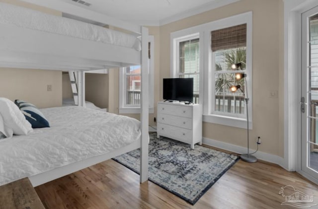 bedroom featuring hardwood / wood-style floors and ornamental molding