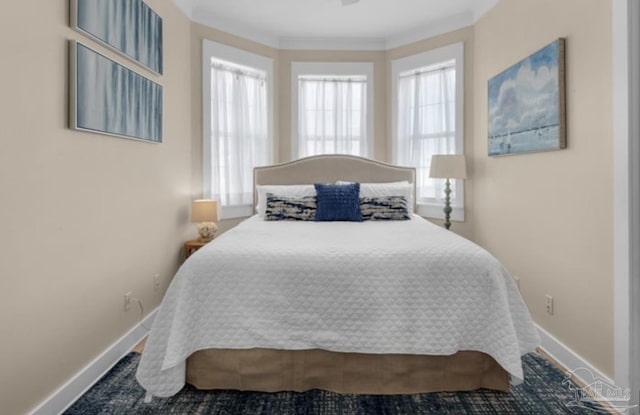 bedroom with multiple windows and ornamental molding