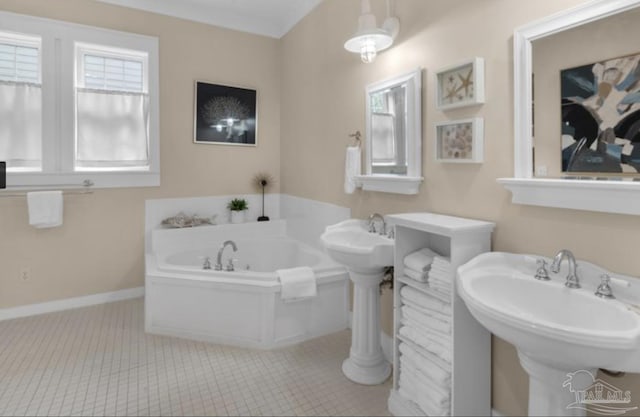 bathroom featuring tile patterned flooring, a bathtub, and dual sinks