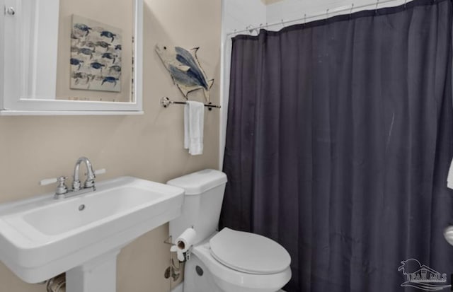 bathroom featuring sink and toilet