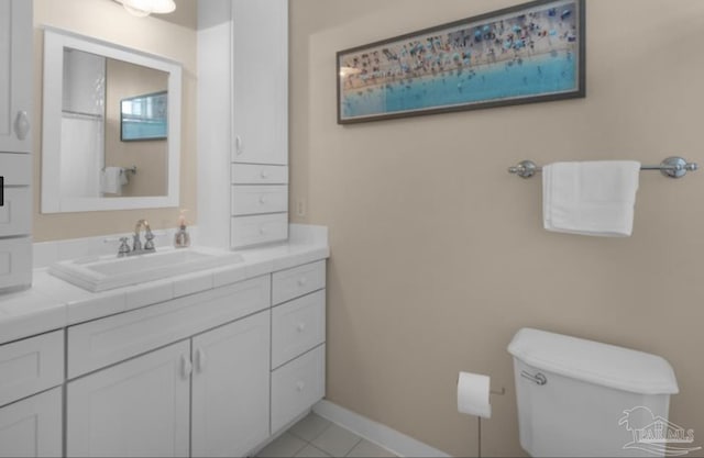 bathroom with tile patterned flooring, vanity, and toilet