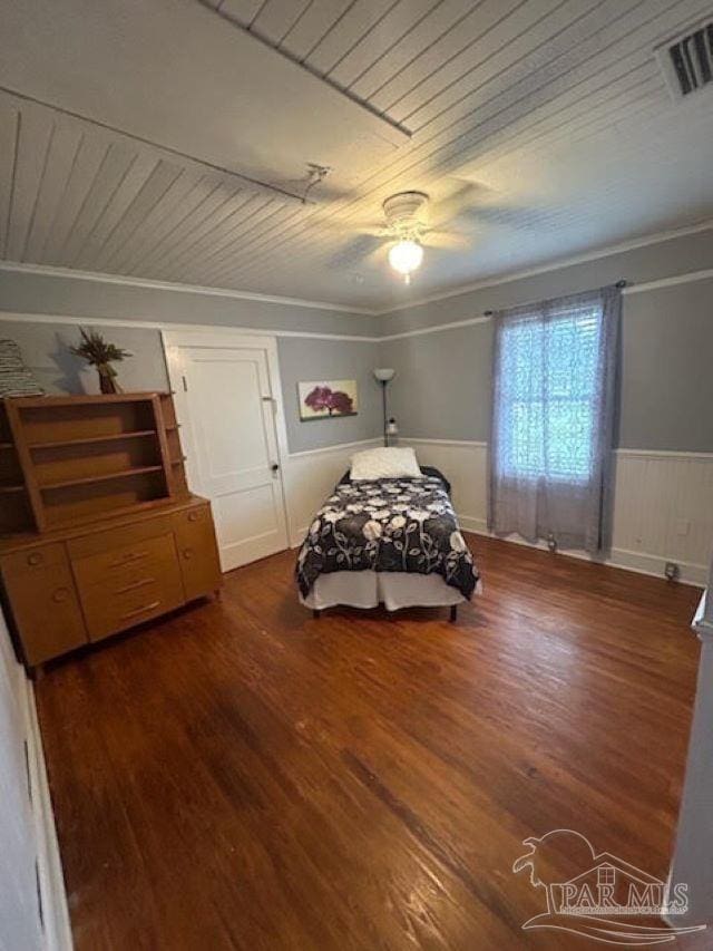 bedroom featuring ceiling fan, dark hardwood / wood-style floors, crown molding, and wooden ceiling