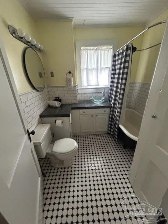 full bathroom with shower / bathtub combination with curtain, toilet, tasteful backsplash, and vanity