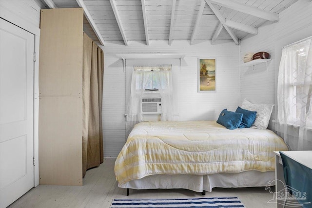 bedroom featuring lofted ceiling with beams, cooling unit, wooden walls, and light hardwood / wood-style floors