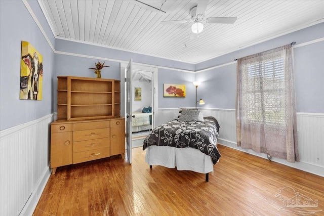 bedroom with ceiling fan, hardwood / wood-style flooring, crown molding, and wooden ceiling