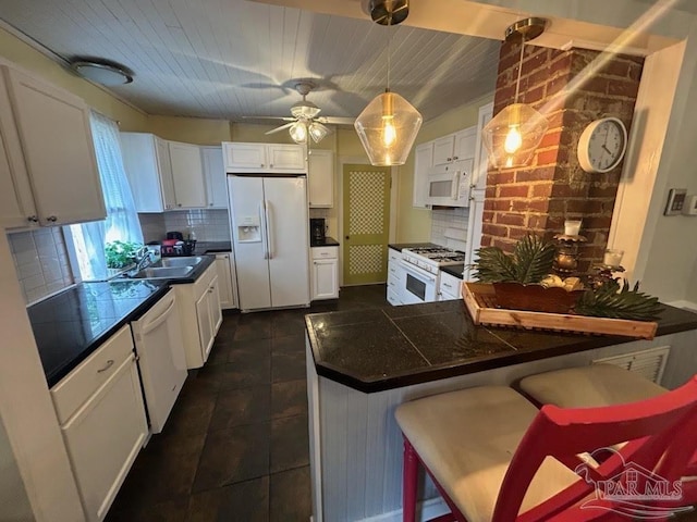 kitchen featuring white cabinets, white appliances, backsplash, and ceiling fan