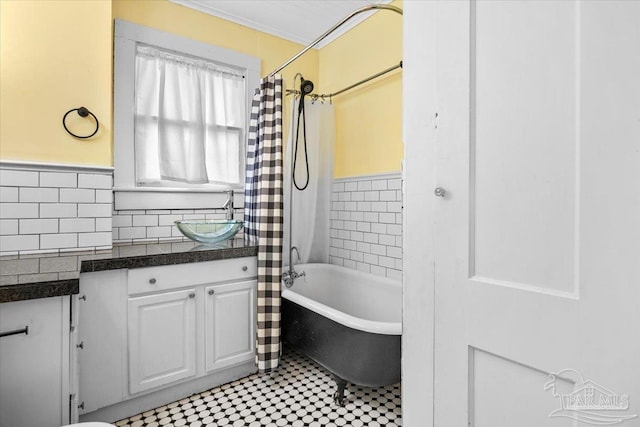 bathroom featuring vanity, ornamental molding, backsplash, and shower / bathtub combination with curtain