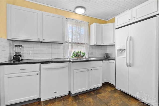 kitchen featuring white appliances and white cabinetry