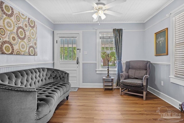 living area featuring crown molding, ceiling fan, wooden ceiling, and hardwood / wood-style flooring