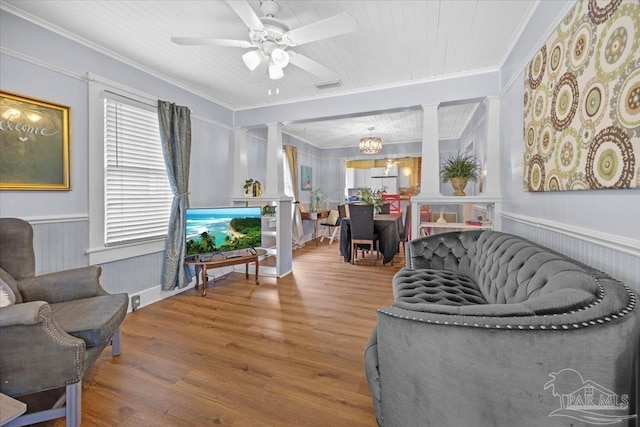 living room with hardwood / wood-style floors, ceiling fan, and ornamental molding