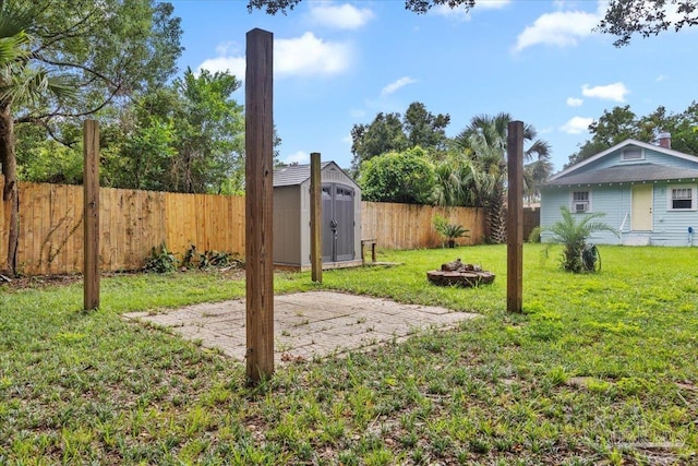 view of yard with a fire pit and a shed