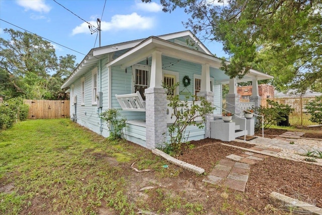 view of property exterior featuring a porch and a yard