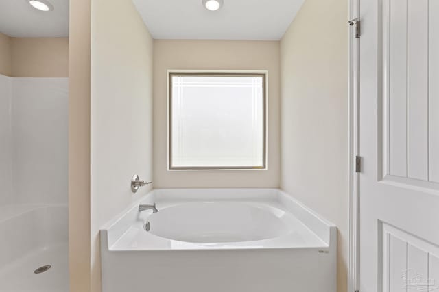 bathroom featuring separate shower and tub