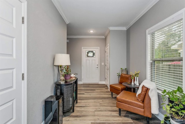 entrance foyer featuring crown molding and light hardwood / wood-style flooring