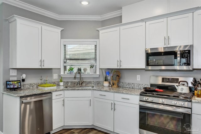 kitchen featuring white cabinetry, sink, crown molding, and appliances with stainless steel finishes