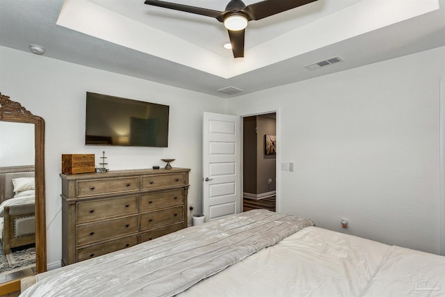 bedroom featuring ceiling fan and a tray ceiling