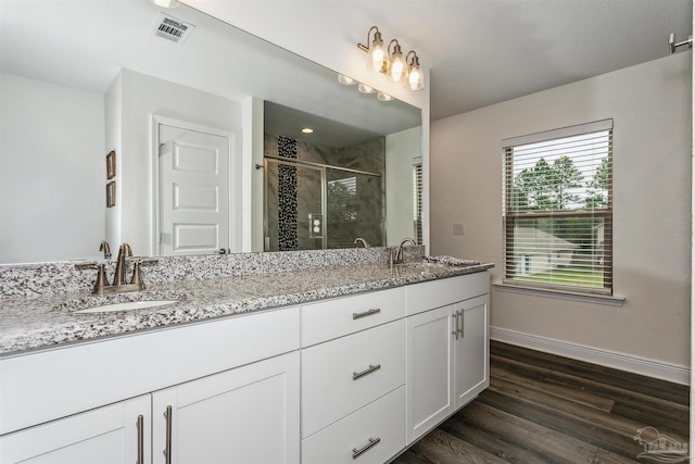 bathroom featuring vanity, an enclosed shower, and hardwood / wood-style flooring