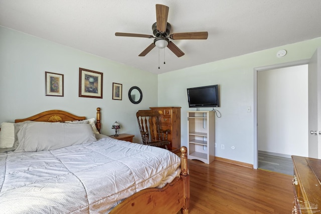 bedroom with hardwood / wood-style flooring and ceiling fan