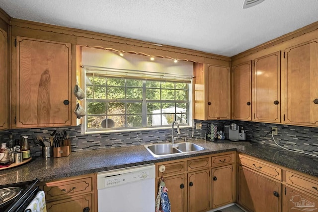 kitchen with dishwasher, range, sink, and tasteful backsplash