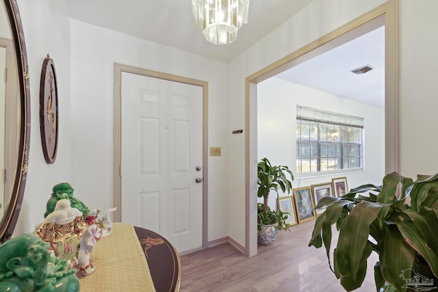 entrance foyer featuring light hardwood / wood-style floors and an inviting chandelier