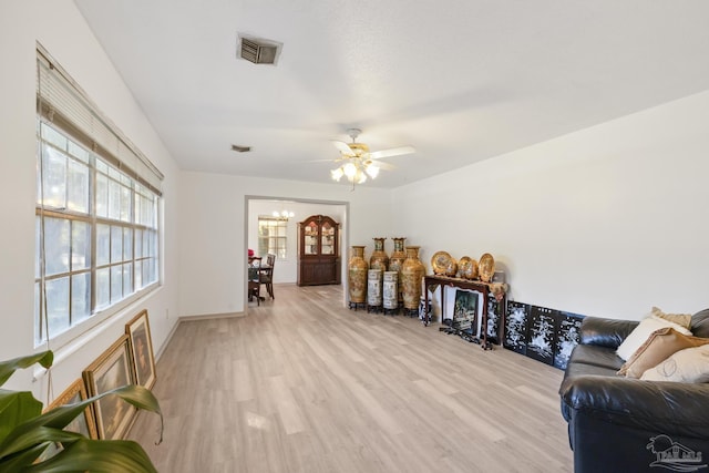 living room with light hardwood / wood-style floors, a wealth of natural light, and ceiling fan