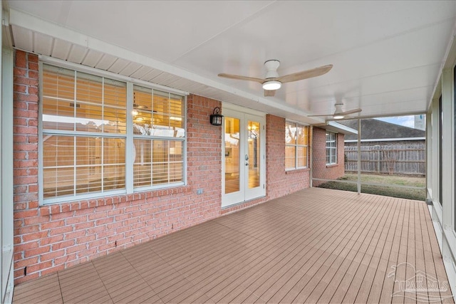 wooden terrace featuring french doors and ceiling fan